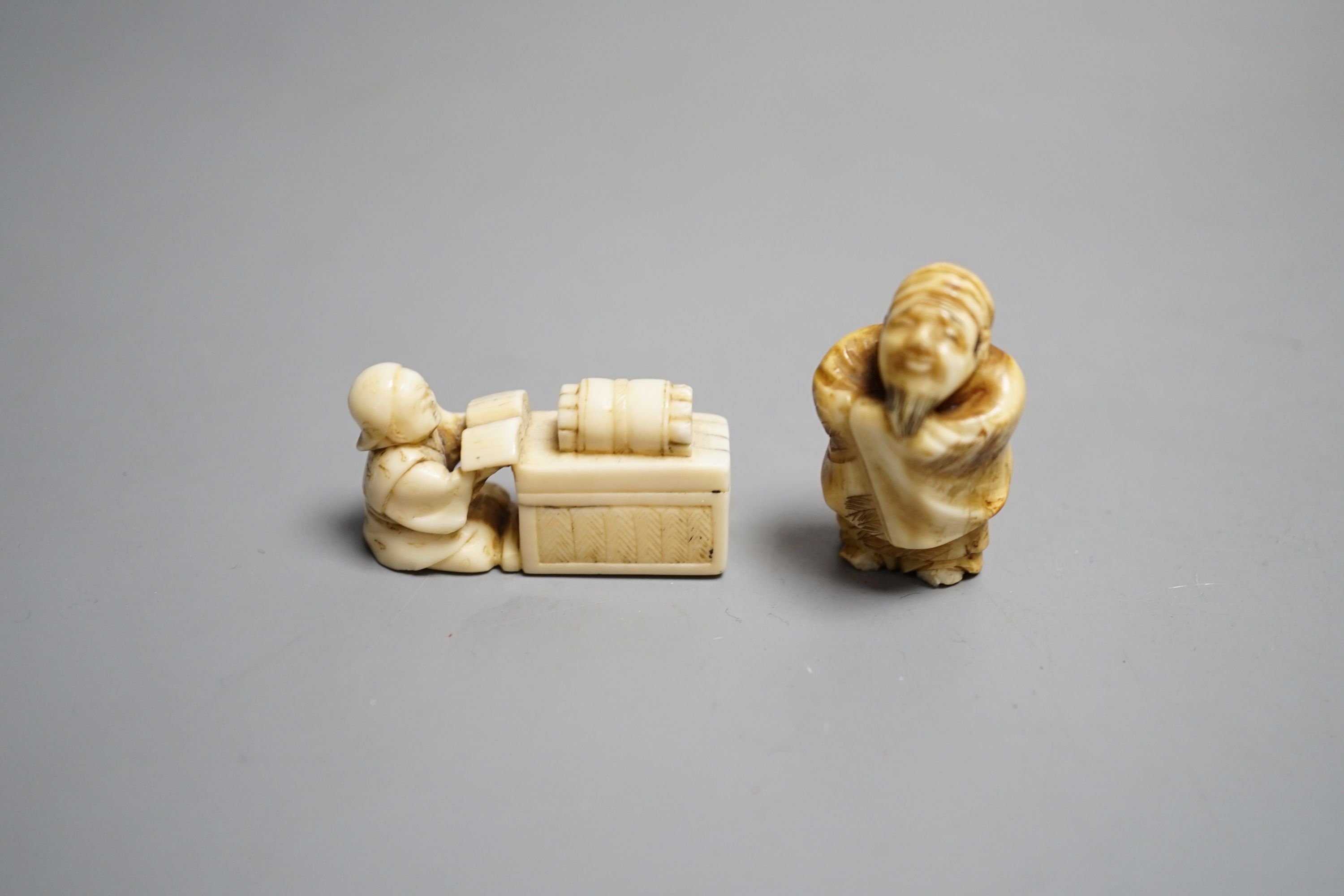 A Japanese ivory netsuke of a man reading a book, a small okimono of Guanyin and monkeys, a Manju netsuke of masks and an early 20th century netsuke of a bearded man